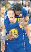  ?? RICK BOWMER — THE ASSOCIATED PRESS ?? Jonas Jerebko (21) is all smiles as he celebrates with Warriors teammates after scoring the winning basket Friday night.