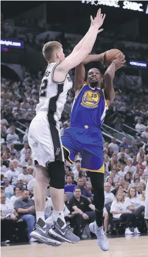  ?? — GETTY IMAGES ?? Golden State’s Kevin Durant drives to the basket against San Antonio’s Davis Bertans in the first half of Saturday’s Game 3 of the Western Conference finals. The Warriors won 120-108.