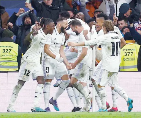  ?? — Reuters ?? Real Madrid’s Karim Benzema celebrates scoring their second goal with Eduardo Camavinga, Luka Modric and teammates during the Copa del Rey Quarterfin­al against Atletico Madrid at Santiago Bernabeu on January 26.