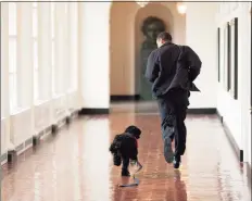  ?? Getty ?? Former President Barack Obama runs through the White House with his dog, Bo, in 2009.