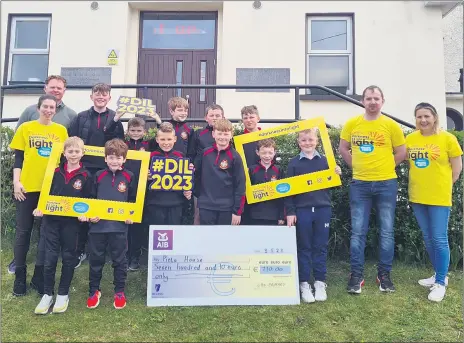  ?? ?? ABOVE - SUPPORTING D.I.L. 2023 - Mitchelsto­wn CBS Primary pupils who were awarded the Amber Flag from Pieta and in the process, raised a whopping €710 for Pieta House and its services. They are pictured with principal Bernard O’Connell and teacher Pamela O’Regan, along with Darkness into Light committee members Lizzie Dineen and Justin Finn, who are now looking forward to Saturday’s event.