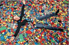  ??  ?? Block party: Nick Harding in a pit of bricks at Lego House in Billund, Denmark