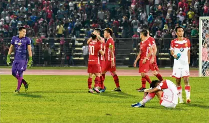  ??  ?? Joy and sorrow: Sabah players (in red) celebratin­g their win over Kelantan in the Malaysia Cup quarter-final second-leg tie at the Likas Stadium in Kota Kinabalu on Saturday. — Bernama