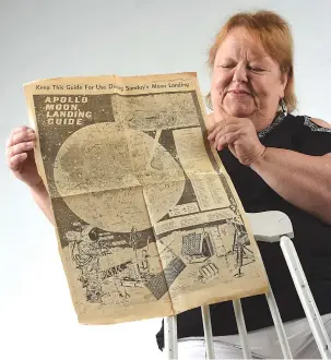  ?? STAFF PHOTO BY TIM BARBER ?? Sharon Sandidge, of Cleveland, holds a newspaper page from the July 13, 1969 edition of the Titusville (Florida) Star-Advocate. She worked for NASA at the time of the Apollo 11 launch.