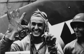  ??  ?? Alexander Vraciu, then lieutenant junior grade with Fighting Squadron 16, holds up six fingers to signify his “kills” during the “Great Marianas Turkey Shoot” of June 19, 1944. The photo was taken on the flight deck of the USS Lexington (CV-16). COURTESY PHOTO NATIONAL ARCHIVES, VIA NAVAL HISTORY AND HERITAGE COMMAND