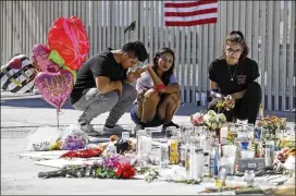  ?? CHRIS CARLSON / ASSOCIATED PRESS ?? Mourners gather at a memorial in Las Vegas, Nev., two days after the Oct. 1 mass shooting there, one of several such incidents that have inflicted a death toll higher than that of the 26 killed in Newtown, Conn., five years ago.