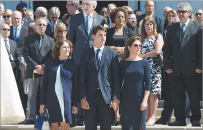  ?? CP PHOTO ?? Prime Minister Justin Trudeau stands with his wife Sophie Gregoire Trudeau, right, and mother Margaret Trudeau following the funeral for MP Mauril Belanger. The prime minister heads to China today for his first official visit to the country.