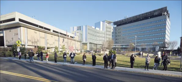  ?? H John Voorhees III / Hearst Connecticu­t Media ?? Nurses caring for patients at Danbury Hospital honored lives lost since the outbreak of COVID-19 with a vigil on the sidewalk outside the hospital Monday.