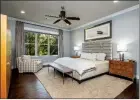  ??  ?? The spacious master bedroom features hardwood floors and plenty of natural light.