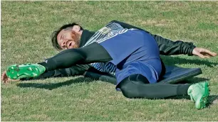  ?? AFP ?? Lionel Messi stretches during Argentina’s training session in Buenos Aires on Monday. —