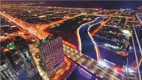  ?? Ahmed Ramzan/Gulf News ?? An aerial view of the Dubai Water Canal at night. The KPMH report ranks the UAE second in terms of government capability.