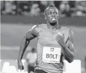  ?? COLLIN REID/ASSOCIATED PRESS ARCHIVES ?? Usain Bolt, shown winning a 100-meter race earlier this year, says a Russia ban sends a “strong message.”