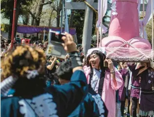  ?? CARL COURT/GETTY ?? A large, pink, phallic-shaped “Mikoshi” is paraded through the streets during Kanamara Matsuri (Festival of the Steel Phallus) on April 1, 2018, in Kawasaki, Japan. The penis is the central theme of the festival, held annually on the first Sunday of April.