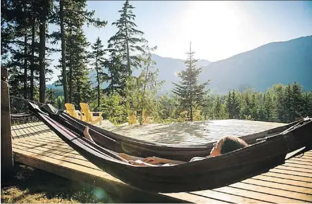  ??  ?? Relax in a hammock in between dips into hot and cold pools during a hydrothera­py session at Scandinave Spa in Whistler.