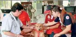  ??  ?? Thai dog Pui is patted by Red Cross staff after discoverin­g a newly born baby in a rubbish dump in Bangkok and carrying her in a plastic bag to safety