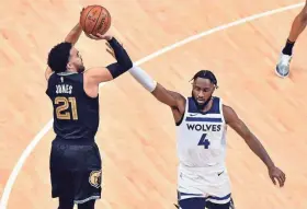  ?? JUSTIN FORD/USA TODAY SPORTS ?? The Grizzlies’ Tyus Jones shoots against the Timberwolv­es’ Jaylen Nowell during Friday’s first half at Fedexforum.