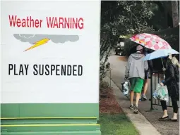  ??  ?? Fans leave Augusta National as play is suspended for a weather warning during a practice round on Wednesday.