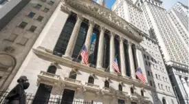  ?? AP PHOTO/JOHN MINCHILLO ?? A pedestrian walks past the New York Stock Exchangin late Janurary in New York.