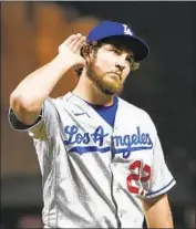  ?? Thearon W. Henderson Getty Images ?? SHOULD he stay or should he go? Accused Dodgers pitcher Trevor Bauer is hearing it from all sides now.