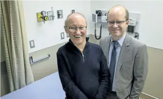  ?? JEFF MCINTOSH/THE CANADIAN PRESS ?? ALS patient Cliff Barr, left, who is taking part in a new Canada-wide clinical trial to treat ALS, poses in an examinatio­n room with trial leader Dr. Lawrence Korngut, in Calgary on Thursday.