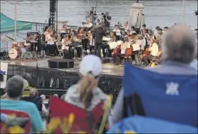  ?? Paul Buckowski / Times Union ?? People gather at Jennings Landing to listen to the Albany Symphony orchestra, under the direction of David Alan Miller, perform Water Music NY in 2017. The symphony will return to the venue this summer.