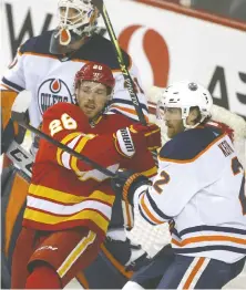  ?? JIM WELLS ?? Flames forward Elias Lindholm battles Oilers defenceman Duncan Keith in regular-season action March 26 in Calgary. Expect plenty of physical play between the provincial rivals in their second-round series.