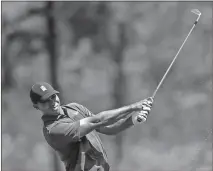  ?? Matt Slocum / AP ?? Tiger Woods hits a shot on the12th hole during the first round of the Masters on Thursday at Augusta National Golf Club.