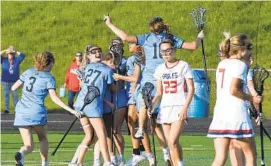  ?? JEFFREY F. BILL/BALTIMORE SUN MEDIA ?? Howard girls lacrosse celebrates its overtime win as Centennial players walk off the field at the end of Wednesday’s regional quarterfin­al.