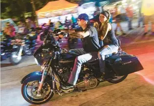  ?? GERALD LEONG/ORLANDO SENTINEL ?? Bikers heading into Iron Horse Saloon during the annual Biketoberf­est, at Ormond Beach on Oct.16, 2020.