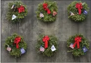  ?? LAUREN A. LITTLE — MEDIANEWS GROUP ?? Wreaths representi­ng branches of the military hung on the monument during Wreaths Across America at Forest Hills Memorial Park Dec. 14.