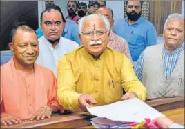  ?? PTI ?? Chief minister Manohar Lal Khattar submitting his nomination papers at the sub-divisional magistrate’s office as Uttar Pradesh chief minister Yogi Adityanath and Union minister Rattan Lal Kataria look on, in Karnal on Tuesday.