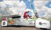  ?? AFP ?? The driver of NWU solar vehicle "Naledi" from South Africa gets out of the car at a control stop on the first day of the World Solar Challenge race.