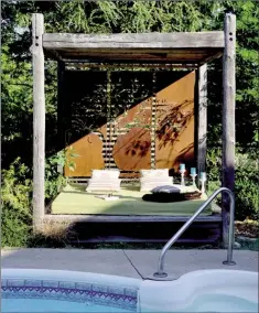  ??  ?? Metal artwork backs an outdoor bed offering beauty and privacy.