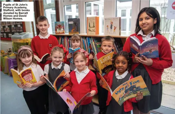  ?? ?? Pupils of St John’s Primary Academy, Stafford, with books donated by Barratt Homes and David Wilson Homes.