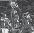  ?? TROY TAORMINA/ USA TODAY SPORTS ?? Alex Bregman shoots a ceremonial first shot before a December Rockets game.