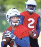  ?? MARK WEBER, THE COMMERCIAL APPEAL ?? University of Memphis quarterbac­k Brady White (left) during the first day of practice for the 2018-19 season.