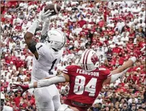  ?? MORRY GASH/ASSOCIATED PRESS ?? Penn State’s Jaquan Brisker intercepts a pass Saturday in front of Wisconsin’s Jake Ferguson to help assure the Nittany Lions’ 16-10 road win over the Badgers in Madison, Wisconsin.