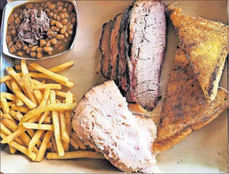 ?? CATHEY/THE OKLAHOMAN] [PHOTOS BY DAVE ?? Smoked turkey and brisket with barbecue baked beans, French fries and toast from Cornish Smokehouse in Oklahoma City.