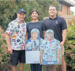  ?? ERIN HOOLEY/CHICAGO TRIBUNE ?? Rick Larsen, left, his wife, Carol, and son Max stand with cardboard cutouts of Larsen and his late friend Mike Koncel on Thursday in Western Springs. The cutouts were placed in the stands at Guaranteed Rate Field during fanless games.