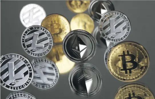  ?? CHRIS RATCLIFFE/BLOOMBERG ?? A collection of bitcoin, litecoin and ethereum tokens. A flurry of recent blockchain announceme­nts by companies big and small has sent stock prices surging.