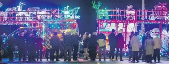  ?? DARREN STONE, TIMES COLONIST ?? Spectators line Dallas Road to watch the 21st annual lighted truck parade as big rigs light up a mild night.