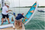  ??  ?? Above: the Iain Oughtred-designed nesting dinghy is bolted together and lowered over the side.
Left: Launch day on the River Hamble