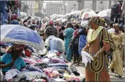  ?? SUNDAY ALAMBA / ASSOCIATED PRESS ?? Pedestrian­s shop Friday in a roadside market in Lagos, Nigeria. Africans were shocked to find President Donald Trump on Thursday used vulgar language to question why the U.S. would accept more immigrants from Haiti and African nations.
