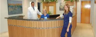  ??  ?? Dr. Farhad Shahian is shown inside South Star Family Dental with office administra­tor Tania Kuhlmann (centre) and dental assistant Jessica Noel.