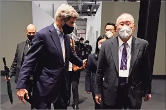  ?? Alberto Pezzali / Associated Press ?? China's chief negotiator Xie Zhenhua, right, walks with John Kerry, United States Special Presidenti­al Envoy for Climate at the COP26 U.N. Climate Summit in Glasgow, Scotland, Friday.