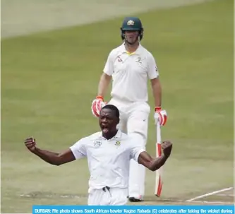  ??  ?? DURBAN: File photo shows South African bowler Kagiso Rabada (C) celebrates after taking the wicket during play on the second day two of the first Test cricket match in Durban. — AFP