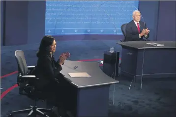  ?? MORRY GASH — POOL PHOTO ?? Democratic vice presidenti­al candidate Sen. Kamala Harris, D-Calif., and Vice President Mike Pence applaud after the vice presidenti­al debate at Kingsbury Hall on the campus of the University of Utah in Salt Lake City.