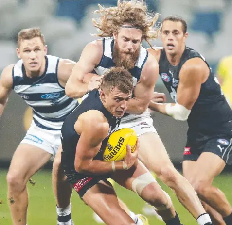  ?? Picture: GETTY IMAGES ?? POWER: Carlton skipper Patrick Cripps beats Geelong’s Cam Guthrie to the ball.