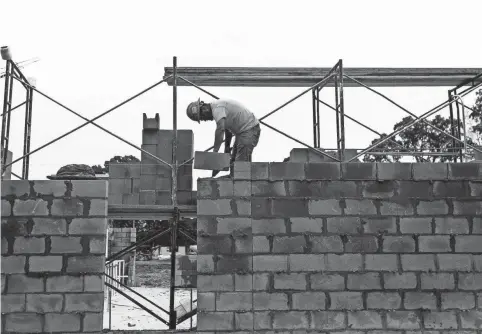  ??  ?? Masonry workers lay cinder block walls as constructi­on continues on Germantown Municipal School District’s new Forest Hill Elementary, which will open next year. MARK WEBER/THE COMMERCIAL APPEAL