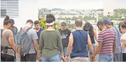  ?? JASPER COLT/USA TODAY ?? Pastor Bert, who is head of an Assemblies of God mission in San Juan, leads a group of volunteers from the U.S. and Puerto Rico in prayer.